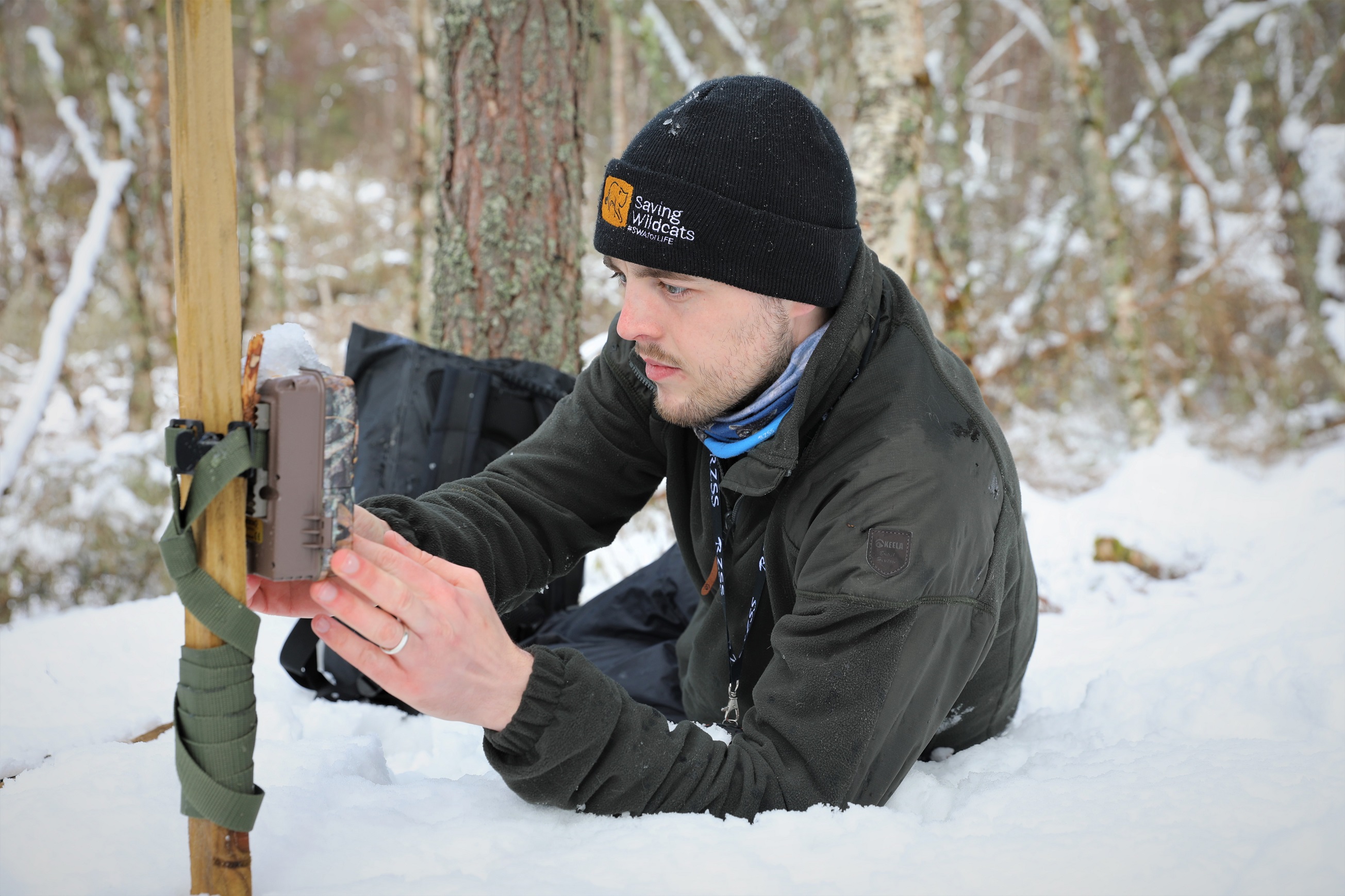 Saving Wildcats field worker Jamie Sneddon fitting a camera trap in the snow

March 2022 
