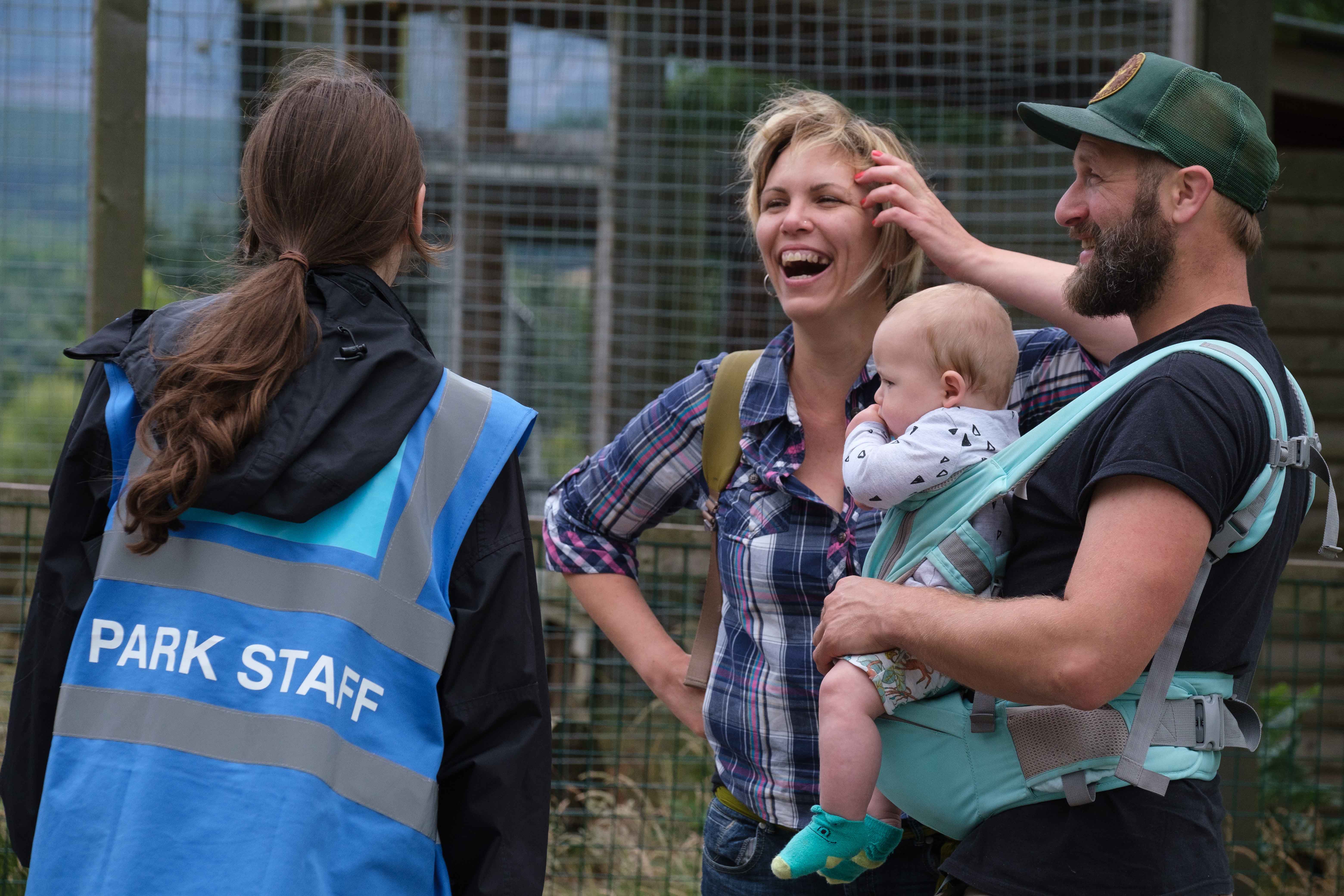 Family of visitors talks with park staff at snow leopard enclosure IMAGE: Robin Mair 2022